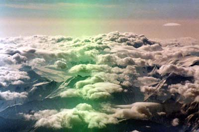 Above the world, the clouds carpet the mountains.