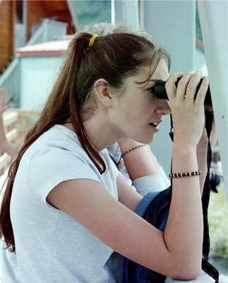 Our granddaughter uses binoculars to search the area