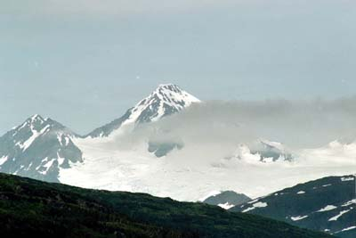 A whisper of a cloud floats over a glacier.