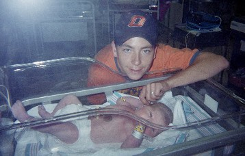 One hour after birth, his son holds his finger