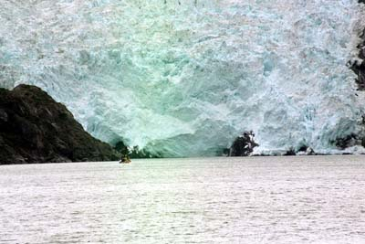 A mile away, a glacier overwhelms a salmon boat.