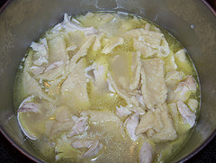 A photo of a pot of chicken and dumplings.