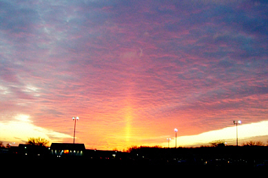 The sun glows as a 4-ray star at sunset