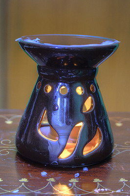 Censer with melted wax around it and on top.