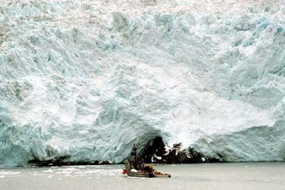 A salmon boat is dwarfed by Blackstone Glacier