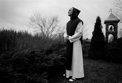 Cistercian Monk reflecting outdoors