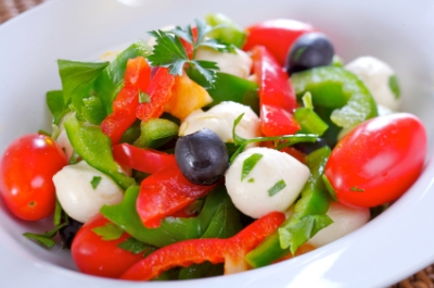 Fresh salad with mozarella, cherry tomatoes, olives and green and red pepper.