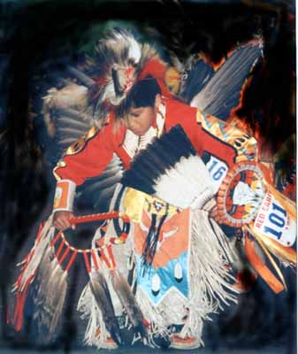 A young Native American dances in a pow wow competition.