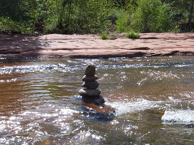 river stones stacked to symbolize a spirit of peace