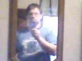 A picture of me, using my reflection from a mirror and a cellphone.