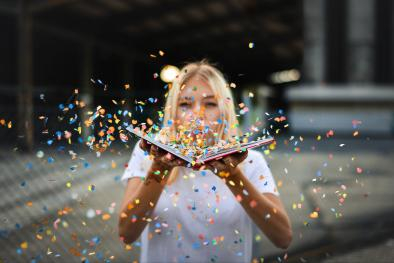 Pixabay image of woman blowing confetti