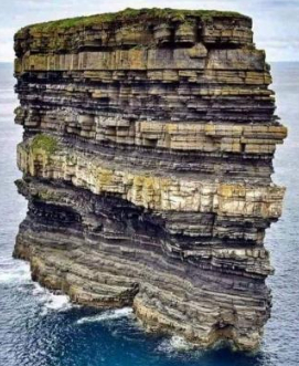 Offshore stack or tower of rock separate from the mainland.