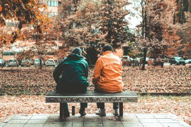 Two friends upon an autumn bench.