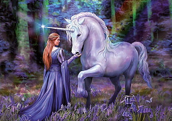 A Princess and her unicorn in the woods. 