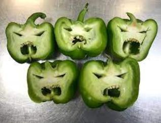 Sliced green peppers looking like faces.