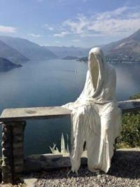 Empty robes placed in a vista of fjord and sunshine.