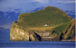 A solitary house on a rugged island.