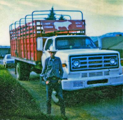 Roy Alan Fisher posing with his stock truck.
