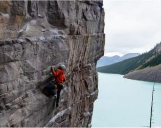 Rock climber on a vertical cliff.