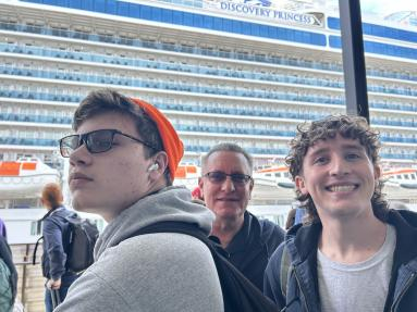 The family waits in line to get on next to the Ship. 
