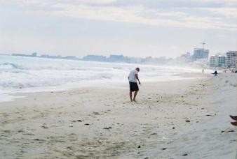 Cancun's beach & hotels ~ Erik walking along the beach behind our hotel. This is in the hotel zone, the beach faces the ocean, so the waves are bigger than the other side that faces the lagoon or the around the corner that faces Isla Mujeres. *Smile*