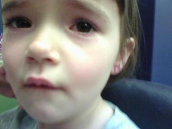 Ouch! ~ Lindsay wanted her ears pierced for her 5th birthday present. This is her right after they were done. She wasn't happy!