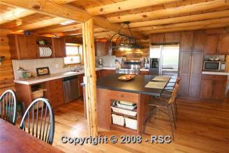 Our New Log Home ~  Our New home, this is the kitchen/dining area.  We also have a 2-story great room.  This is a 3 story level custom log home on 60 acres with a log barn to match, four stalls and tack room with run outs, all acreage fenced and cross fenced.  We moved in Nov 21, 2009, right before Christmas. 