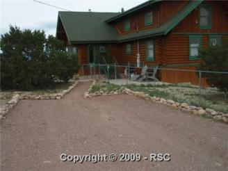 Our New Log Home ~  Another picture of our new home.  This is a 3 story level custom log home on 60 acres with a log barn to match, four stalls and tack room with run outs, all acreage fenced and cross fenced.  We moved in Nov 21, 2009, right before Christmas. 