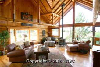 Our New Log Home ~  Our New home, the Great Room overlooking mountains. This is a 3 story level custom log home on 60 acres with a log barn to match, four stalls and tack room with run outs, all acreage fenced and cross fenced.  We moved in Nov 21, 2009, right before Christmas. 
