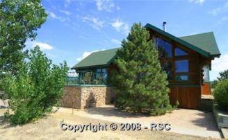 Our New Log Home ~  Our New home, the prow front overlooking mountains.  A two-story great room.  This is a 3 story level custom log home on 60 acres with a log barn to match, four stalls and tack room with run outs, all acreage fenced and cross fenced.  We moved in Nov 21, 2009, right before Christmas. 