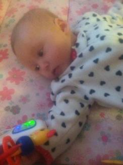 02-01-2013 ~  I hooked up Rosalie's Baby Einstein to the portable playpen. Here she is pushing the button and playing with the handle rollers. *Smile* 