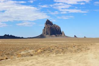 Shiprock ~  Shiprock (Navajo: Tsé Bitʼaʼí, "rock with wings" or "winged rock") is a monadnock rising nearly 1,583 feet (482.5 m) above the high-desert plain of the Navajo Nation in San Juan County, New Mexico, United States. Its peak elevation is 7,177 feet (2,187.5 m) above sea level. It lies about 10.75 miles (17.30 km) southwest of the town of Shiprock, which is named for the peak.

 Governed by the Navajo Nation, the formation is in the Four Corners region and plays a significant role in Navajo religion, myth, and tradition. It is located in the center of the area occupied by the Ancient Pueblo People, a prehistoric Native American cultur...